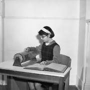Blind & Deaf Institute, visually-impaired girl reading Braille text, possibly then transcribing to Braille typewriter, 1951 to 1976